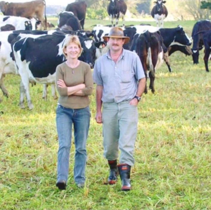 Farm workers standing with the dairy herd